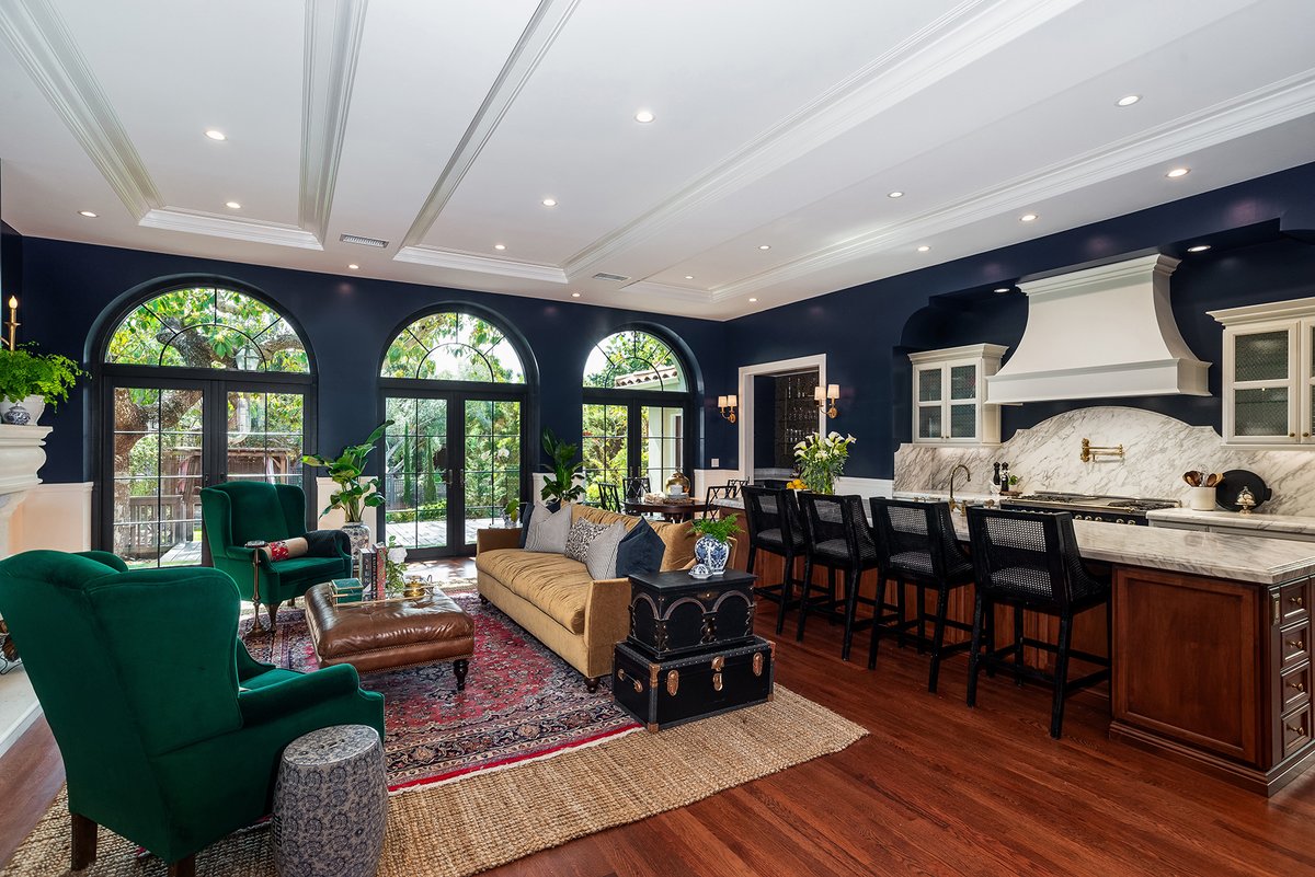 An addition to a historic home built in 1937 allowed for this expansive kitchen and living space with a trio of stunning windows &amp; French doors, now connected to the beautiful backyard.