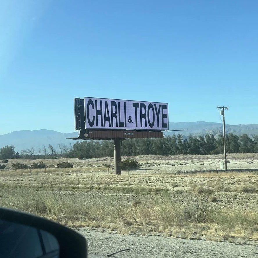 Coachella billboard teases a Charli XCX & Troye Sivan collaboration.