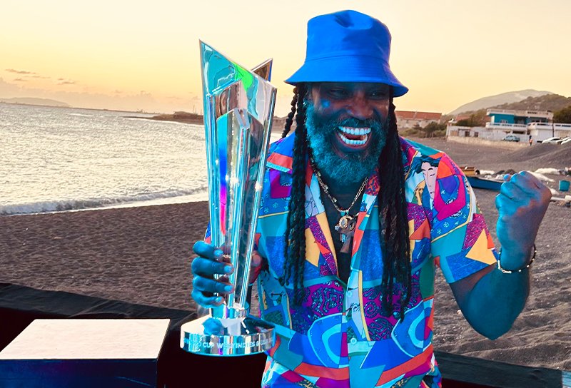 Chris Gayle, the Universe Boss, poses with the T20 World Cup trophy during its tour in Barbados!🏆