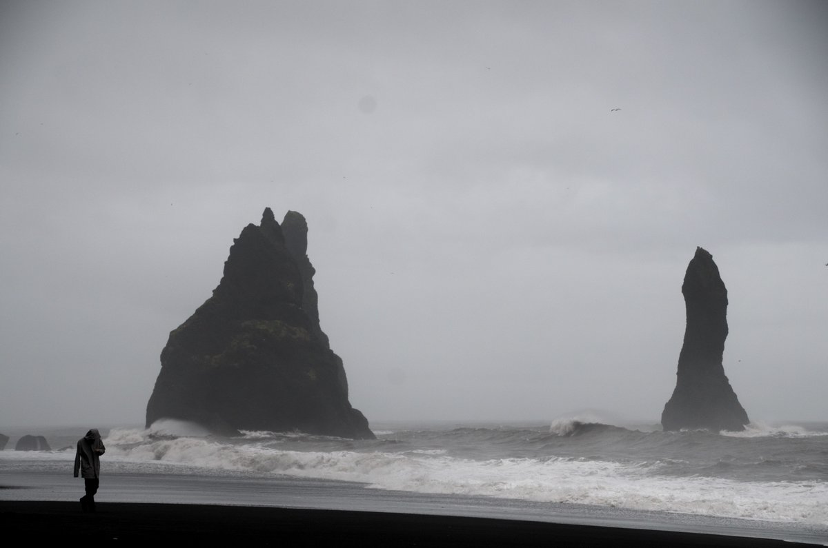 'Braving the Wind' by Wendy Zeller Zigaitis. The dark basalt columns & black sand beaches of Reynisfjara, Iceland are popular, but the intense ocean currents make the water unsafe, proving that a landscape can be both alluring & hazardous.

#LSGPhotoCompetition #AAG2024