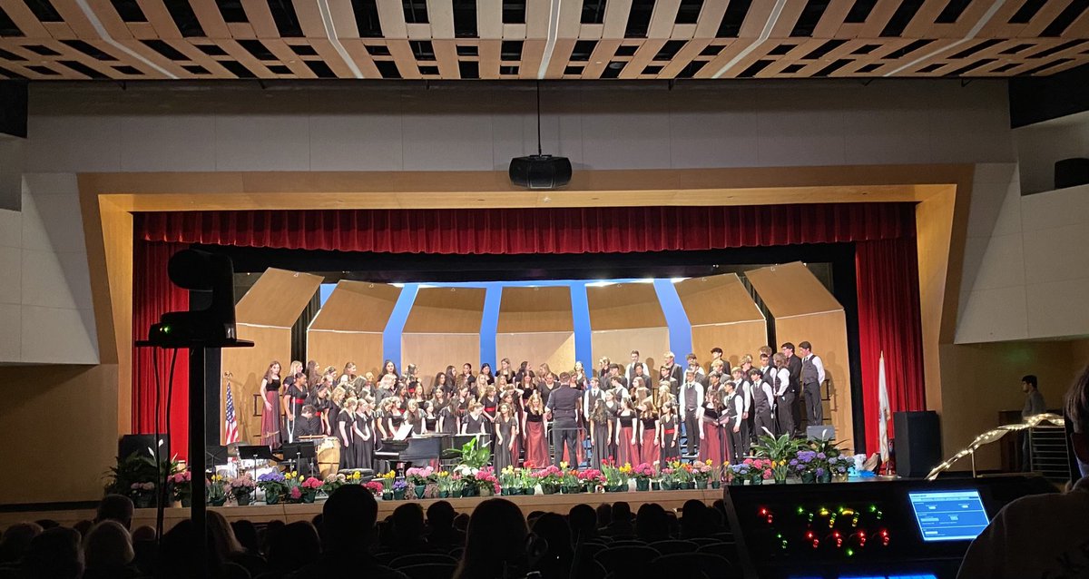 WinMusicFriends's tweet photo. Apologies for the hard to see photos!  The stage looked gorgeous with spring flowers and the kids sounded amazing!  Can you see that Mr. B was wearing a boa?  Last photo cred Coach Fleming (singing and volleyball go together!) https://t.co/ra2PAHWeeY
