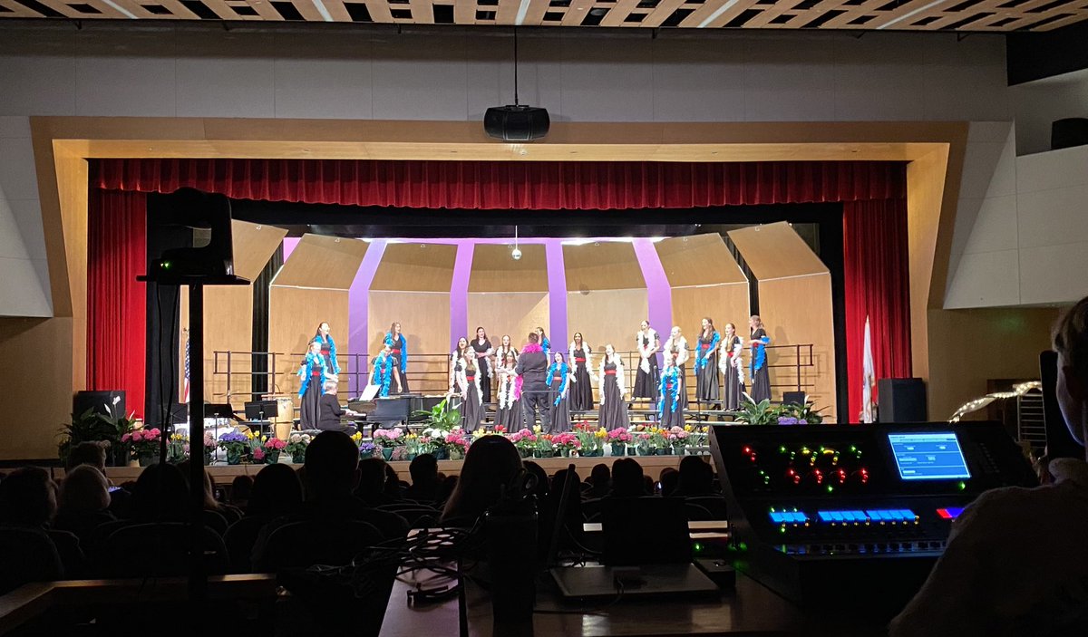 WinMusicFriends's tweet photo. Apologies for the hard to see photos!  The stage looked gorgeous with spring flowers and the kids sounded amazing!  Can you see that Mr. B was wearing a boa?  Last photo cred Coach Fleming (singing and volleyball go together!) https://t.co/ra2PAHWeeY