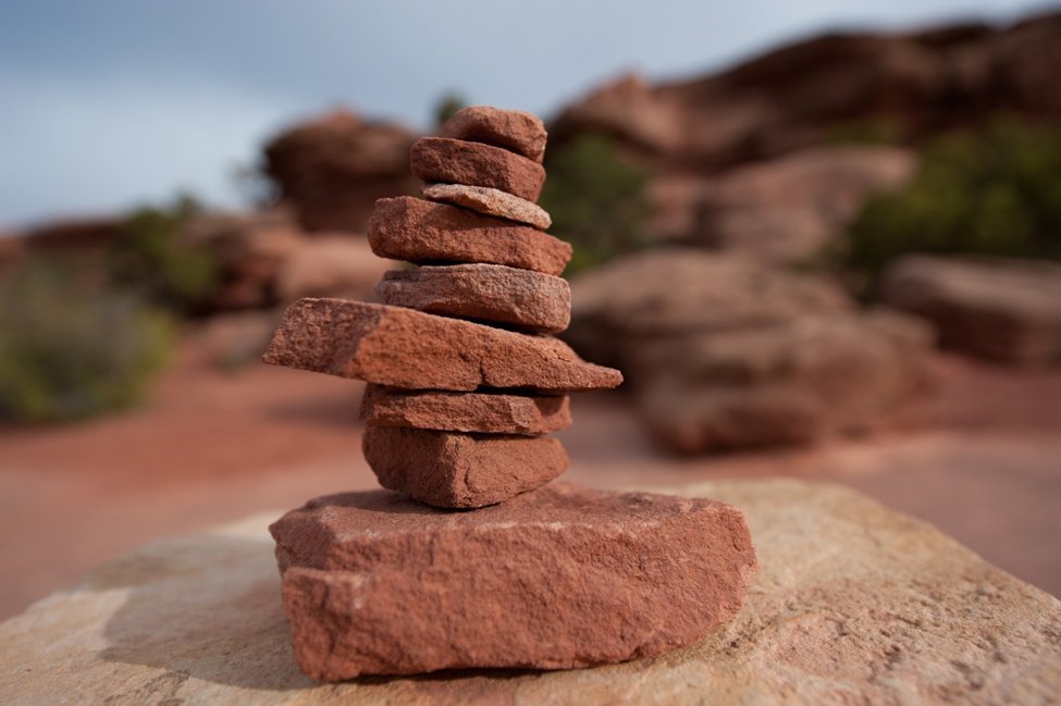 When hiking in the park, you may notice stacked rocks along the trail. These are called cairns. Rangers build cairns to help mark where to go on the trails. It is important to leave rocks where you find them and avoid knocking over existing cairns over to protect our living soil!