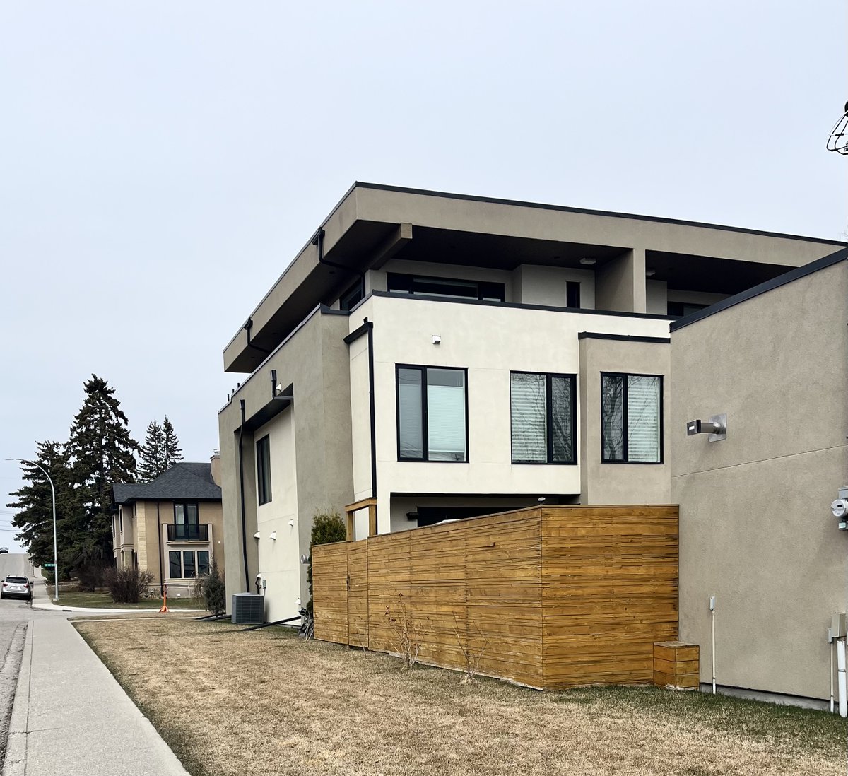 Either side of a lane in upper Bankview: Rowhouse (RCG) on the left, semi detached dwelling (RC2) on the right. Similar height, similar lot coverage, rowhouse has far more trees and vegetation, no vehicles parked on the street. This debate is not about community character.