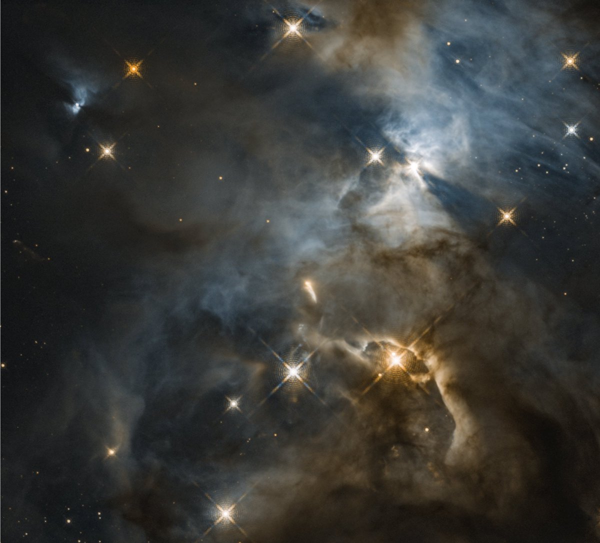 April showers bring May flowers. 🌼 In 2018, Hubble captured this image of the Serpens Nebula, a star-forming region that resembles stormy clouds on a spring day. This reflection nebula is home to a unique feature known as the “Bat Shadow”: bit.ly/3IOR4tk