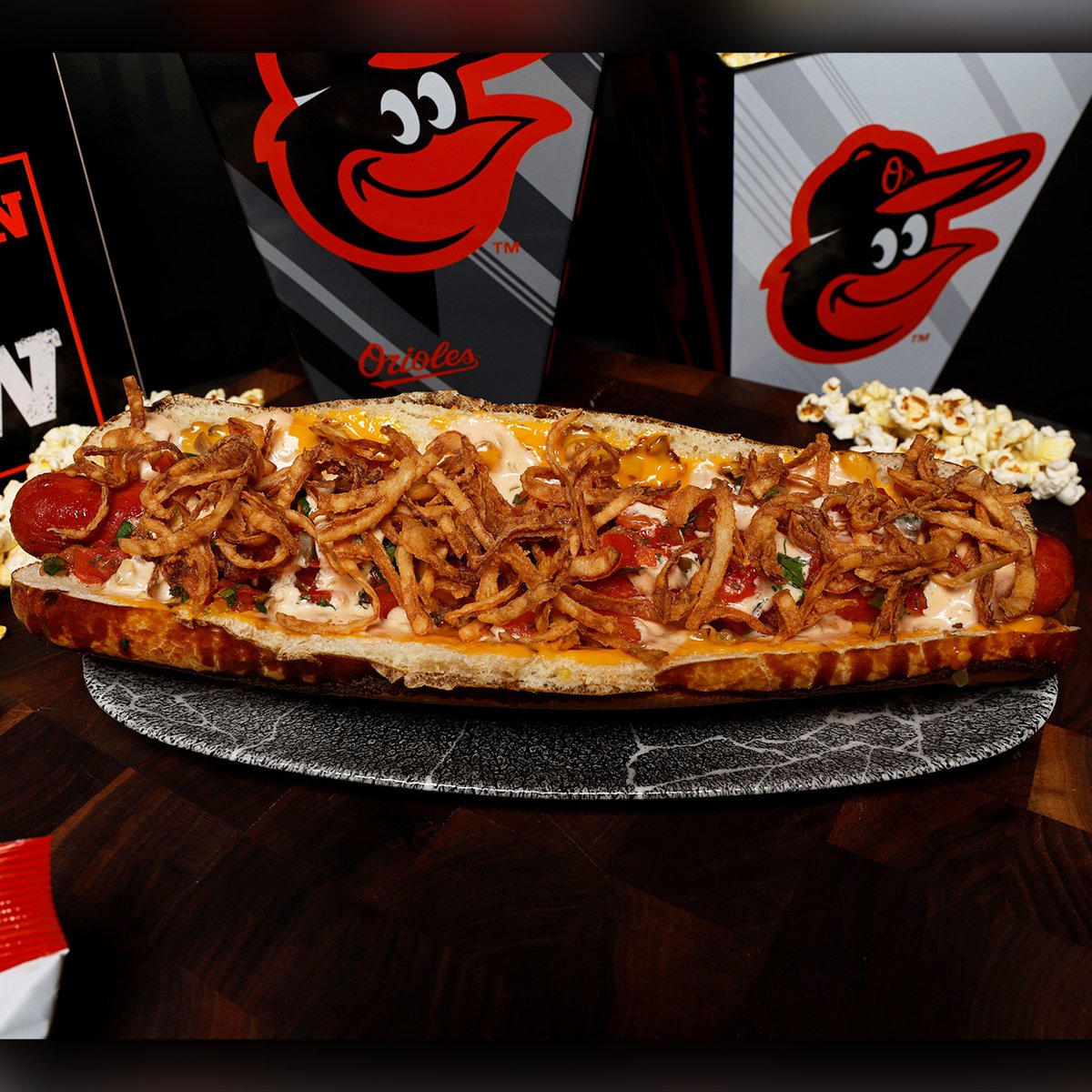 The Orioles will have a fully loaded foot-long hot dog at home games this year called 'The Warehouse Dog' 😳 It's a 12-inch dog with horseradish-infused brick sauce, pit beef queso fundido, pickled pico and onions on a pretzel bun Who could eat a whole one of these? 😂