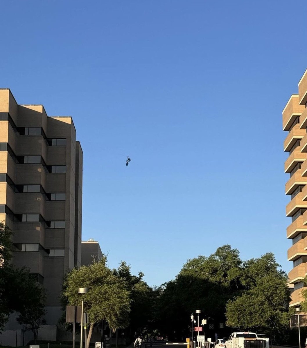 RustySuretteTV's tweet photo. 🚳 The College Station Fire Department is on A&amp;M’s campus helping to get a bicycle down that was left dangling between two buildings. 

📸; Andrew Billingsley and Katy Grace https://t.co/NU6vi2m5Ll