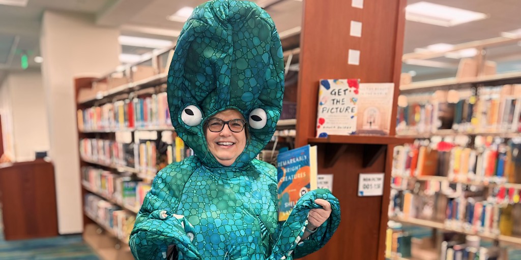 BBCityLibrary's tweet photo. It's Fantasy Friday at the Boynton Beach City Library in celebration of National Library Week! Our Library Director, Jeannie Taylor, is dressed up as Marcellus from "Remarkably Bright Creatures" by Shelby Van Pelt. 📚🎉 

#NationalLibraryWeek #BoyntonLibrary #LibraryFun https://t.co/KJaNWThF19
