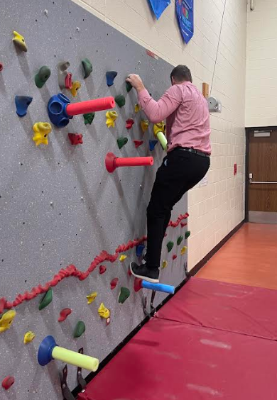 LT Ball principal tries the climbing wall.