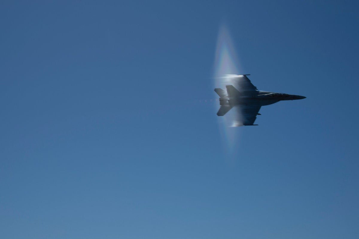 An F/A-18F Super Hornet breaks the sound barrier while practicing for an air power demonstration above the Nimitz-class aircraft carrier USS Abraham Lincoln … dvidshub.net/r/xe9z5h #Navy