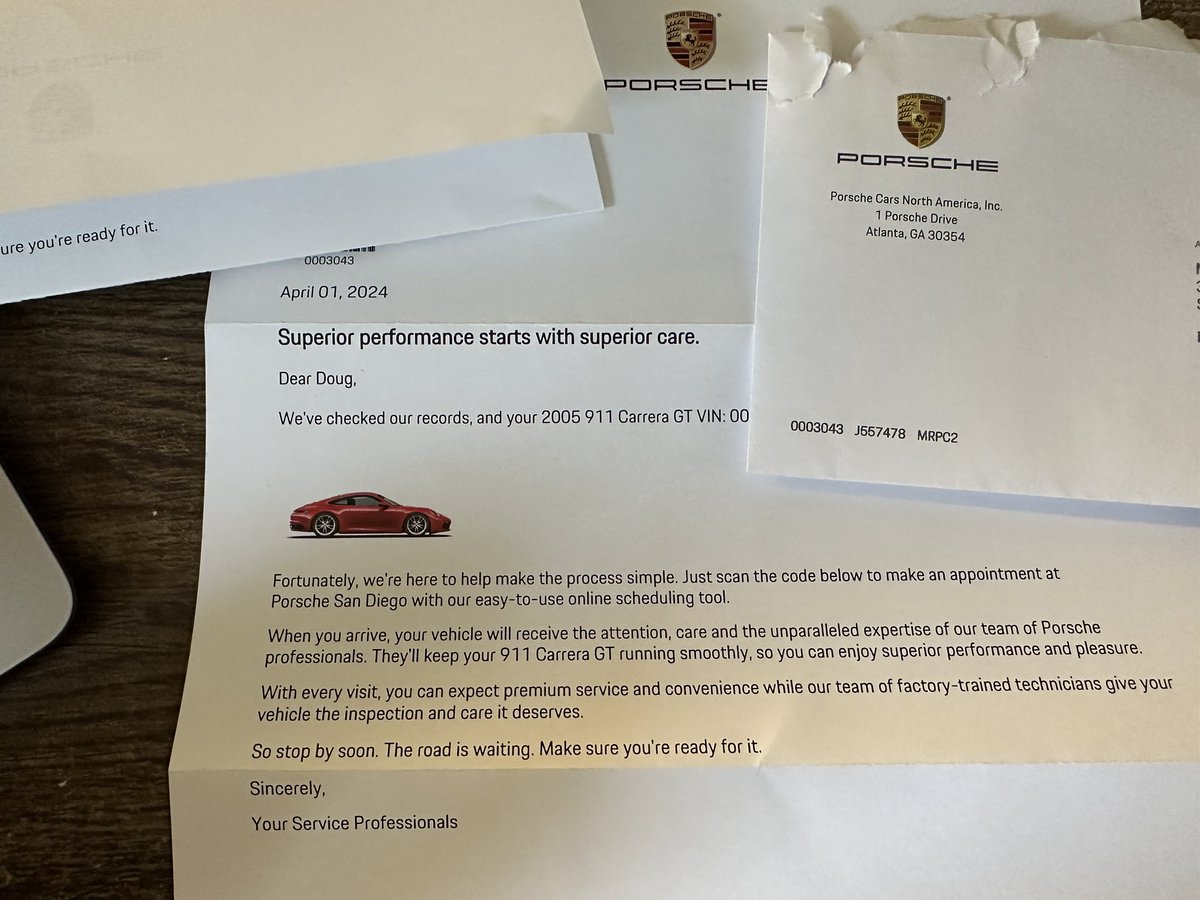 Here’s a letter from Porsche NA about scheduling service for my “2005 911 Carrera GT,” which also shows a picture of a red 991. 🤔