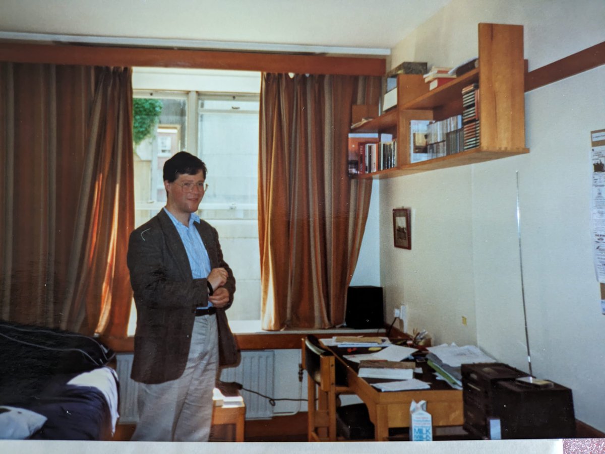 Me in my university room c1992 where the orange-brown theme lingered from the last time it was redecorated some time in the late 70s. Nylon carpet too!