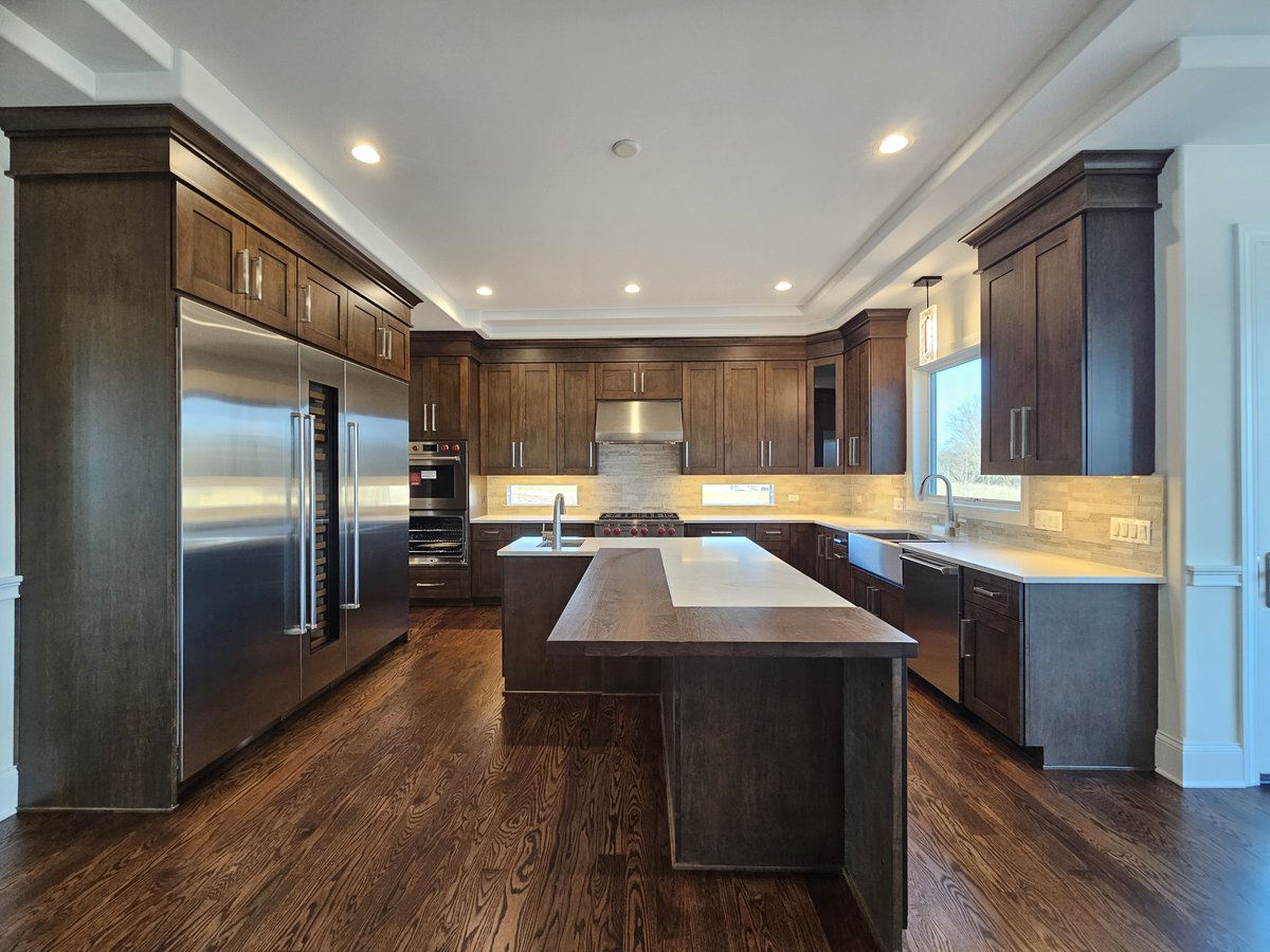 The darker #cabinets in this #kitchen gives it a warm feeling. Lovely! Our #modelhome is open from 11 am - 5 pm at 4012 Alfalfa Ln #Naperville #newhome #newhomedesign #newhomebuilder #newhomeconstruction #homebuilder #homeconstruction #customhome #customhomebuilder #kitcheninspo