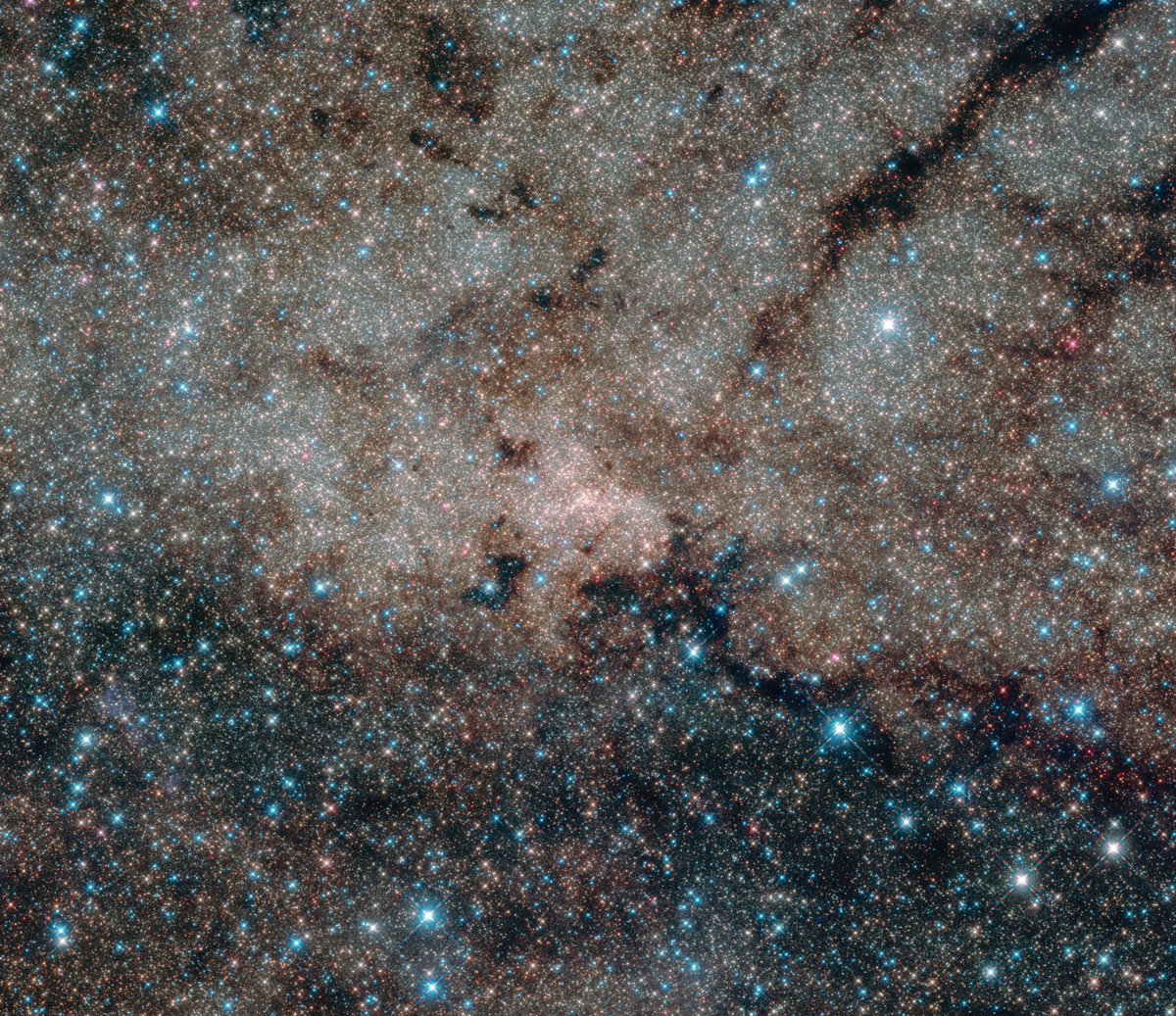 Dive into the stunning complexity of our galaxy's core! This image makes you ponder the countless worlds hidden in these star clusters. Credit: NASA, ESA, and the Hubble Heritage Team (STScI/AURA), T. Do, A. Ghez (UCLA), V. Bajaj (STScI)