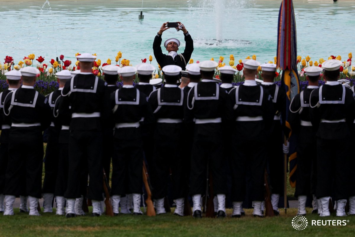 U.S. Navy sailors pose for a group photo in the South Lawn of the White House, in Washington. Photo by @tombrennerphoto