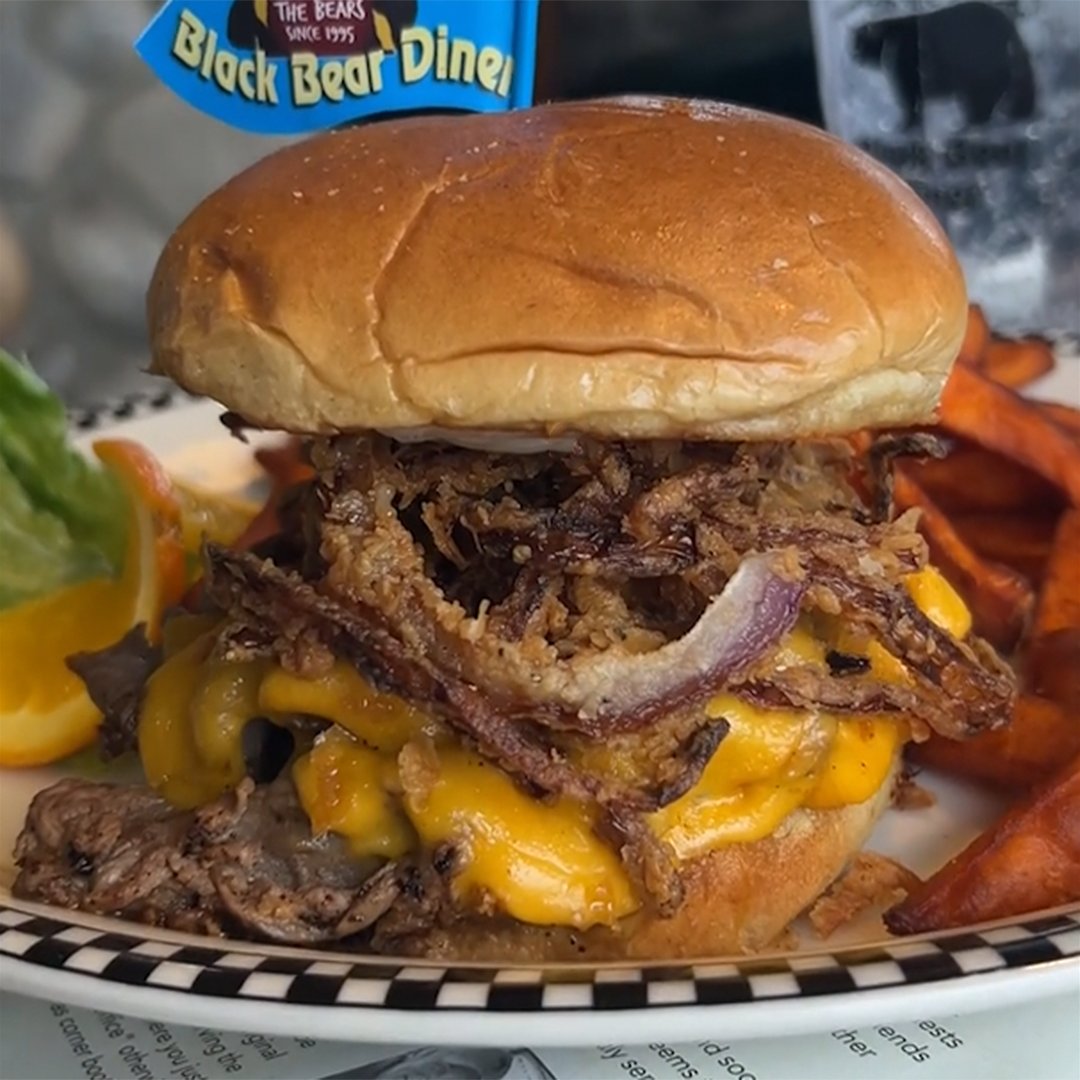 Meet the Tri-Tip Cheddar Stack, piled high with our thin sliced Santa Maria seasoned tri-tip, then layered with cheddar cheese, homemade onion straws and our homemade garlic-Dijon aioli, all on a garlic Parmesan buttered & toasted brioche bun. Sound yummy? bit.ly/4cV5tSj