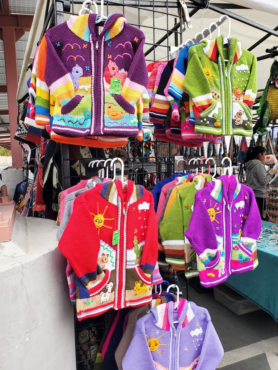 💖 We absolutely adore these little knitted jackets. Delightfully colorful, they make for a unique gift for the grandkids! #thingstodoinpalmdesert #outdoorshopping #streetfair