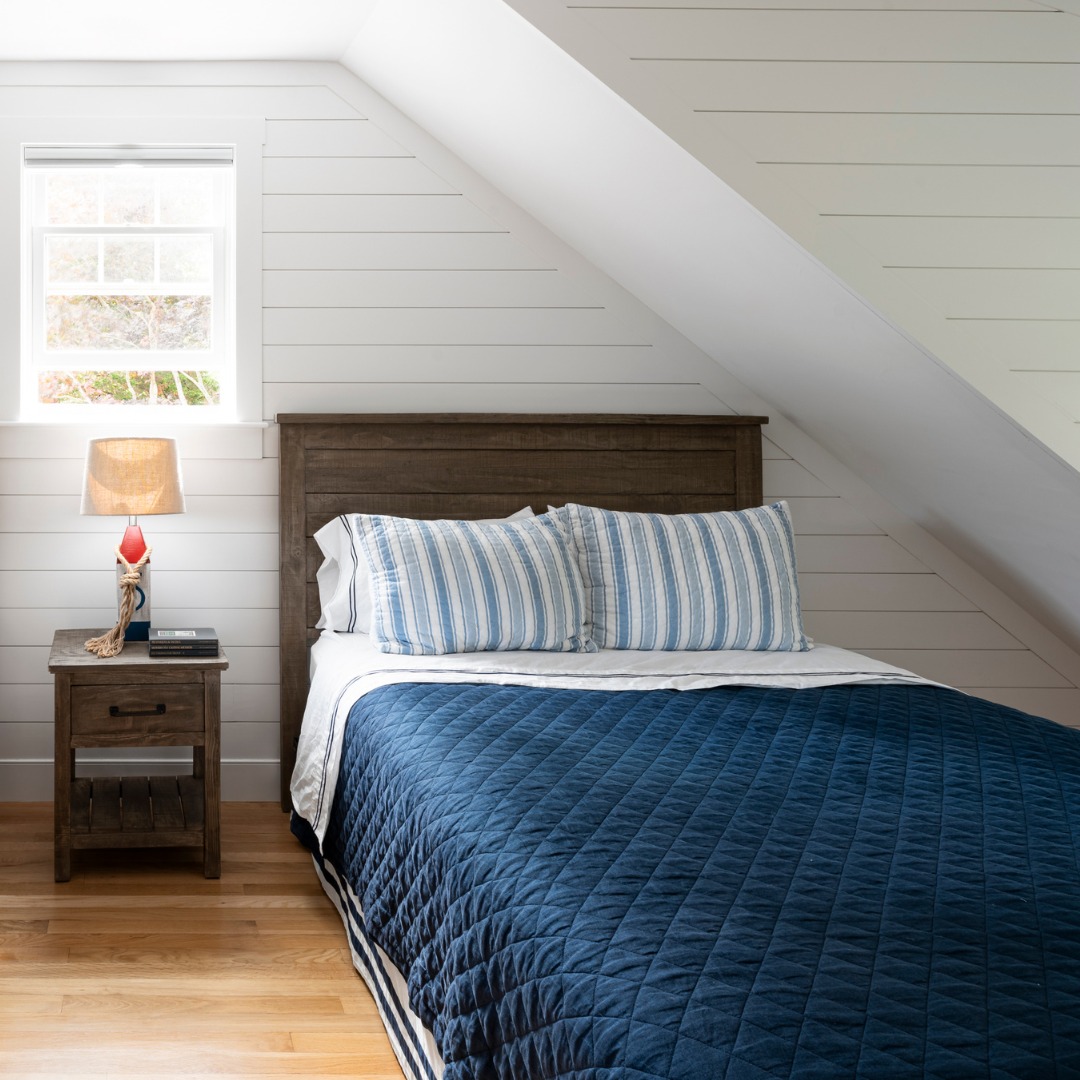 Shiplap adds texture and visual interest to nearly-white bedroom walls.

#BuiltByPhilbrook in collaboration with A3 Architects, inc, Andersen Windows + Doors, Shepley Wood Products #CapeCodHome #CapeCodLiving #OrleansMA 📷 Grattan Imaging