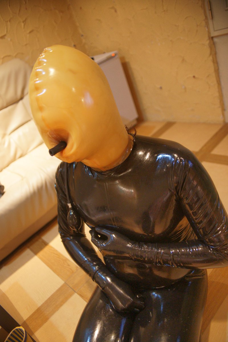 latex catsuit. inflatable mask.
