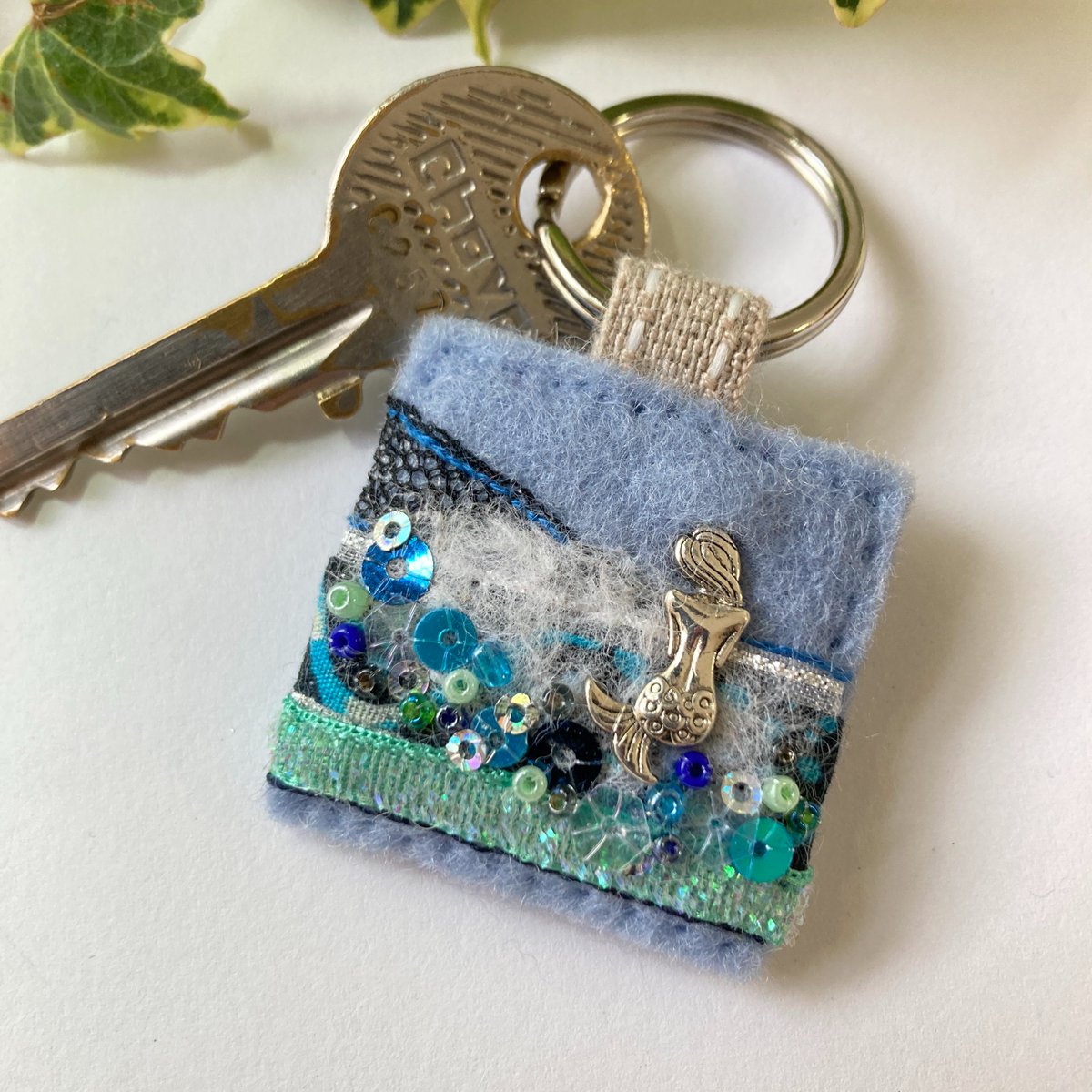Beautiful mermaid keyring hand sewn in cool ocean colours from mixed fabrics, trims and embellishments. elliestreasures.square.site/product/mermai… #EarlyBiz #MHHSBD #shopindie #mermaid #uniquegifts