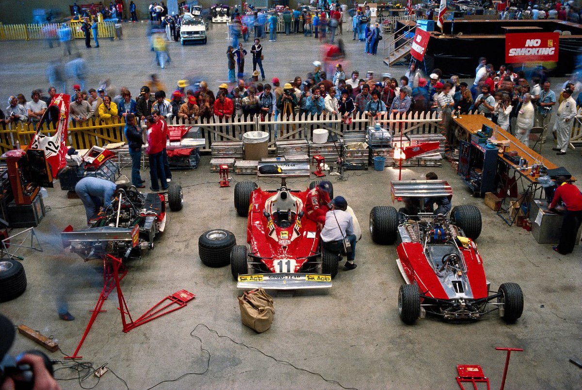 1977 . US Grand Prix West (Long Beach) . Fans watch mechanics work on a Ferrari 312T2 in garages organized at the sports arena.

#F1 #USGP #Ferrari
