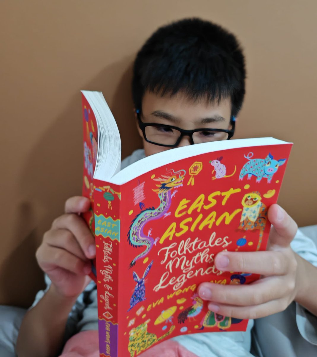 He’s reading this because #RepresentationMatters East Asian Folktales, Myths and Legends by @scholasticuk out now in the world!