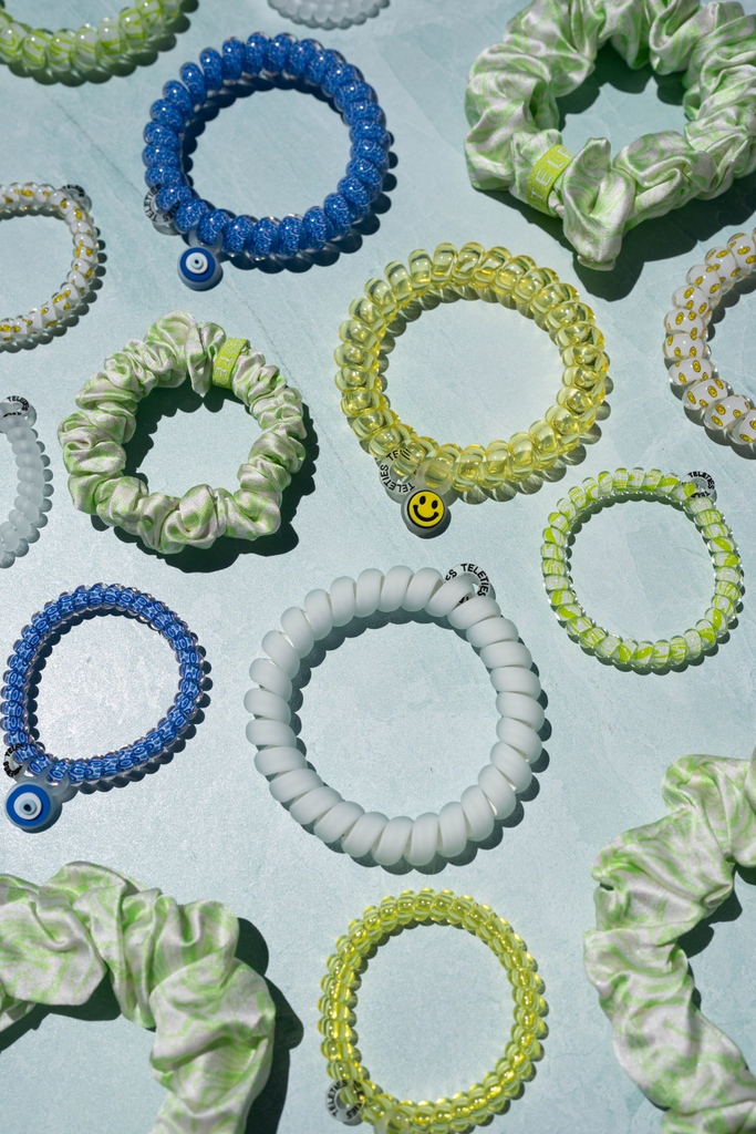 🎉 It's here, Cool Kids!⁠ Get ready to rock the coolest hair accessories with our smiley, evil eye, and green swirly printed hair ties, scrunchies, and clips! 🙂🧿💚🌀