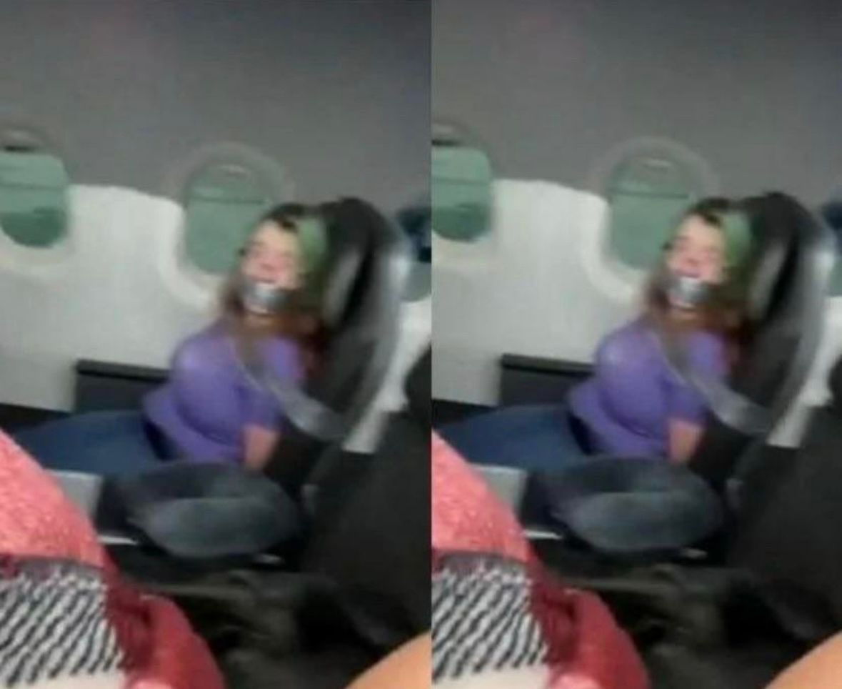 This lady was duck taped to her seat on a plane after trying to open the door mid flight.