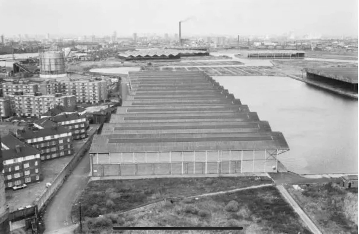 The sheds of Canada Dock basin as viewed from the Canada Est towers and the Pump House. The far end being where The Range/Tescos etc now stand. On the left Albion Estate, Swan Road, Beech House etc #Rotherhithe #Bermondsey #SE16