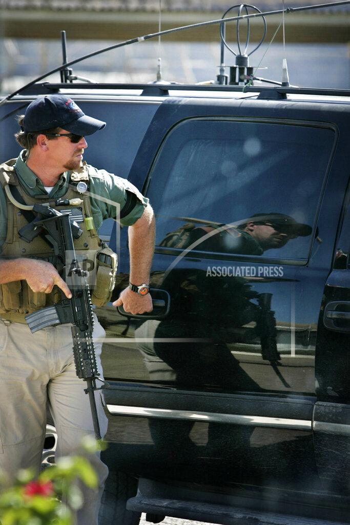 A Blackwater security contractor guards the convoy of U.S. Ambassador to Iraq Zalmay Khalilzad during a tour of Mosul, 360 kilometers (225 miles) northwest of Baghdad, Iraq, in a Sunday, Sept. 25, 2005 photo. (AP Photo/Jacob Silberberg)