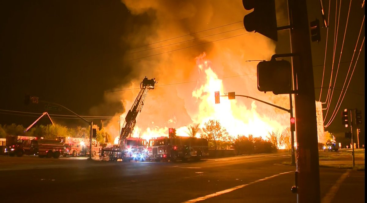 That massive warehouse fire continues to burn in Tracy this morning. At least 15 engines have responded. On the streets bordering the fire, our camera's see powerlines and transformers engulfed in flames. We have a live report from the scene all morning long on @kcranews