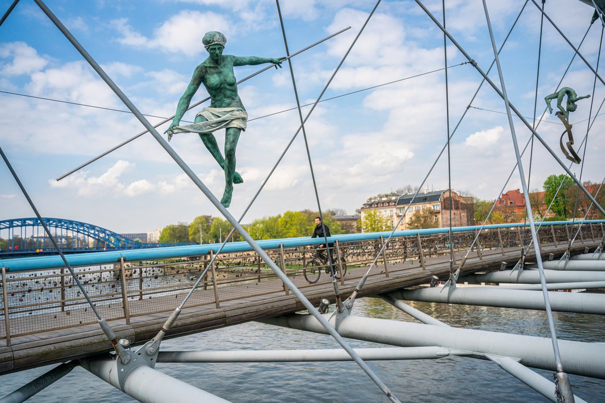 Have you spotted the gravity-defying statues in Krakow? This leaf-shaped wonder spans the Wisła River, offering pedestrians and cyclists alike a scenic journey. Jaw-dropping sculptures by Polish artist Jerzy Kędziora add an extra twist to your walk. #visitpoland #polandtravel