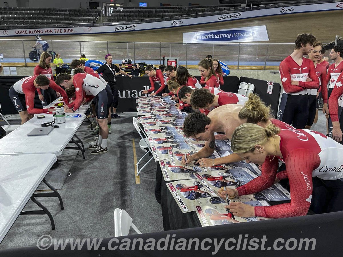 Team Canada signing posters for supporters and fans