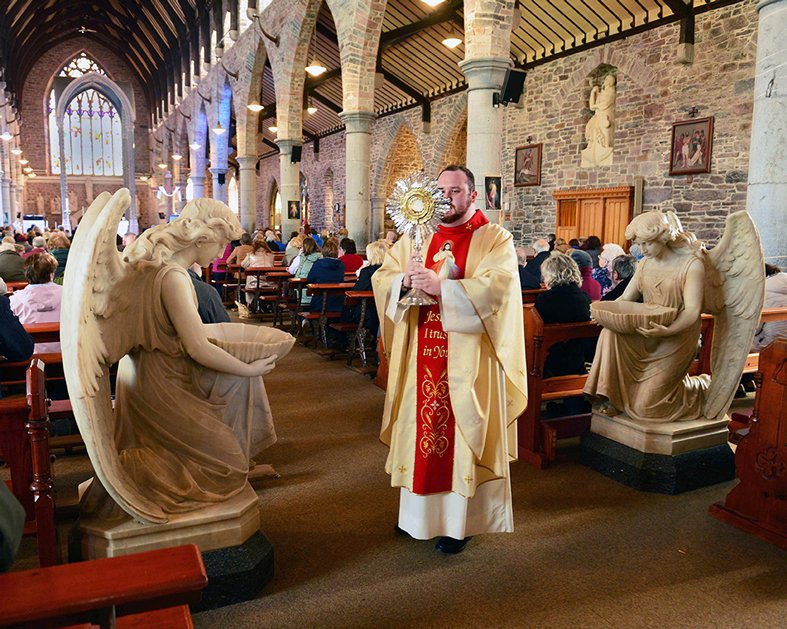 Blessing the people attending the Divine Mercy Sunday devotion celebrated by Fr Mark Moriarty at St John’s Church Tralee, Co. Kerry. Photo: John Cleary