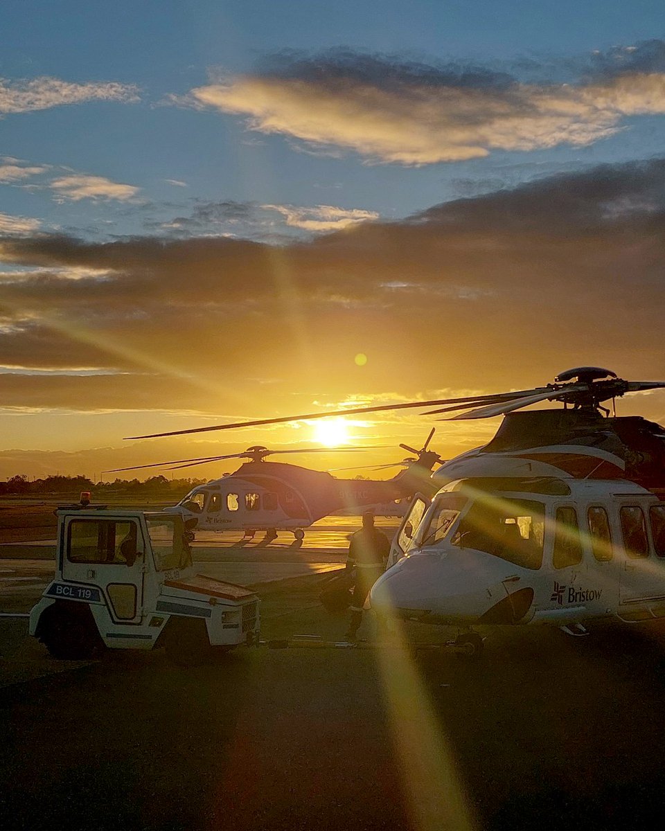 Nothing beats a golden sunset. Get a look at these two AW139s sitting on the ramp while beams of sunlight peak through the clouds and between the rotor blades, creating a beautiful shot worthy of a front page magazine. #ProudToBeBristow #Views #Aviation #Sunset #Helicopters