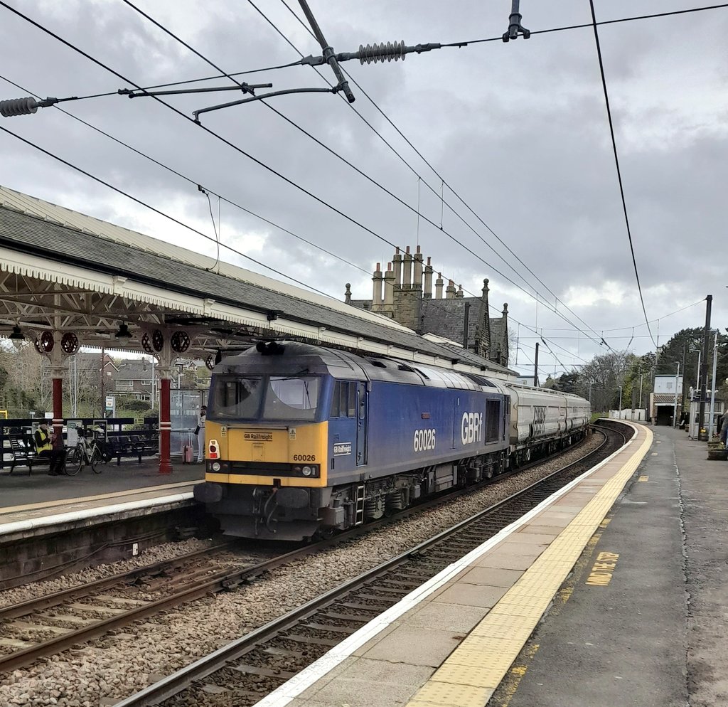 60026 'Helvellyn' brings up the rear of 6N87 Biomass Empties through Morpeth Station.