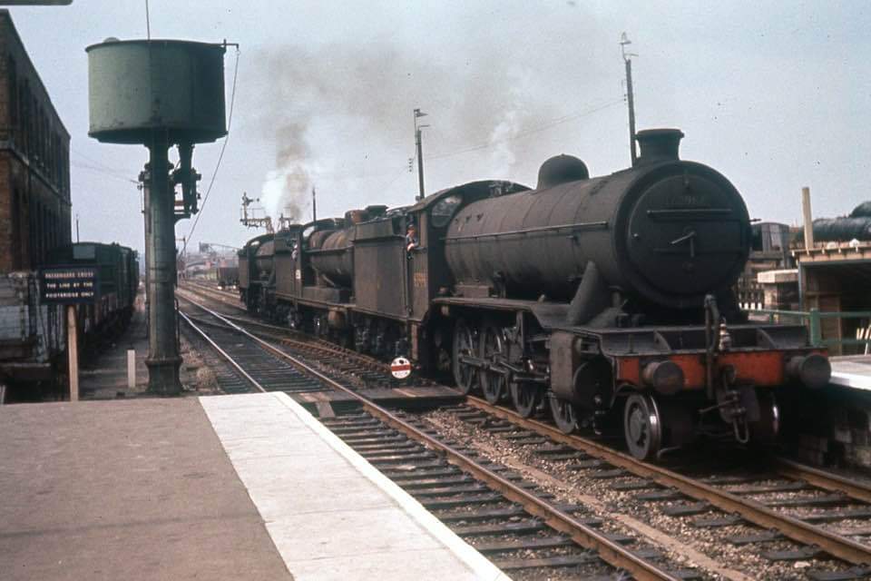 Class O2s 63954 and 63986 together with Class 04 63586 pass Worksop heading east towards Retford in August 1961. Colour Rail scan.