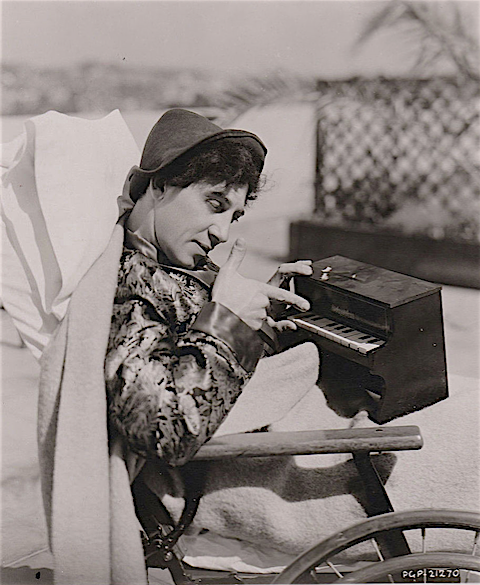 Chico 'playing a little piano' as he recovers from an auto accident in April of 1932 that shattered his knee and broke several ribs. 'Horse Feathers' filming was held up for 2 months and when he returned to do the football scene, he was wearing heavy leg guards and he limped.