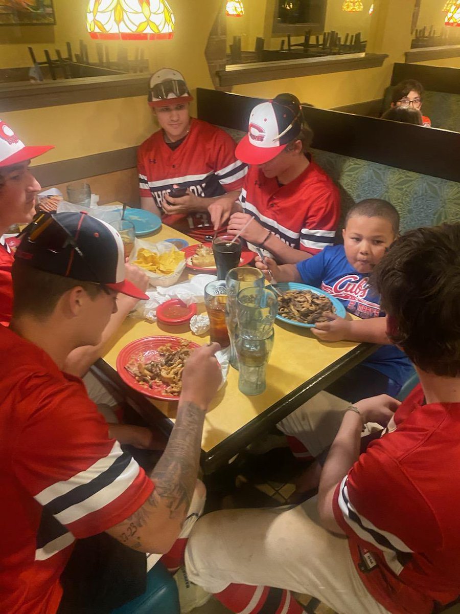 Our baseball players found a baseball fan and invited him to sit with them.