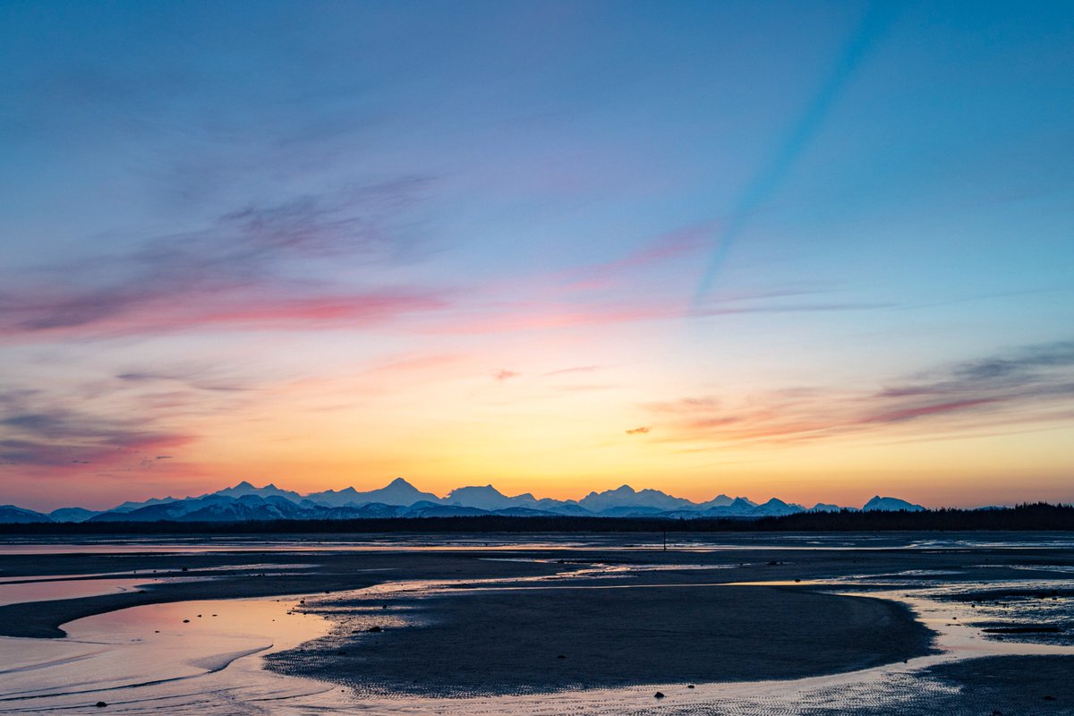 Glacier Bay's neighboring community of Gustavus features one of the best panoramic views in Southeast Alaska. In April, the sunset casted this incredible shadow drawn by the summit of 15,325' Mt Fairweather. Learn more about Gustavus: nps.gov/glba/planyourv…