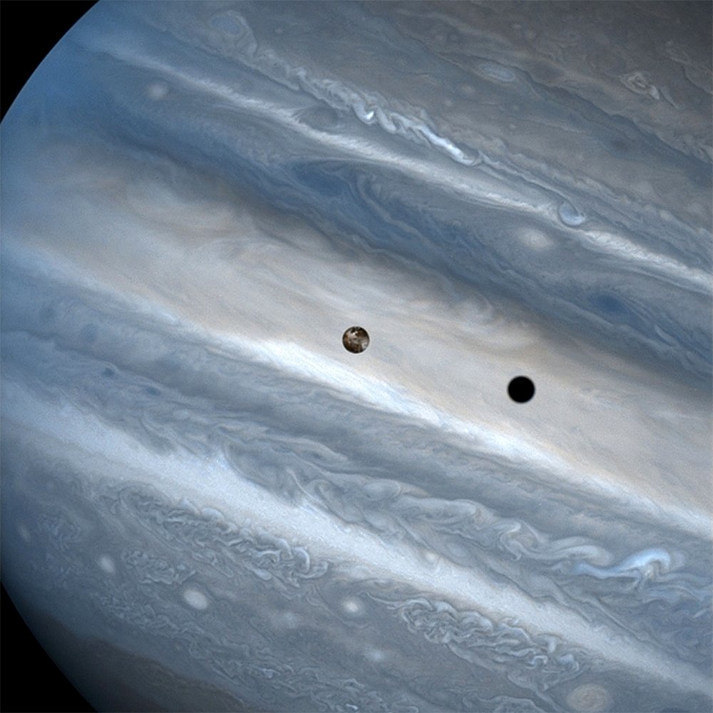 This is a photo of Jupiter's moon Io eclipsing the Sun. Io is in the centre of the image; its shadow is the darker circle to the right.