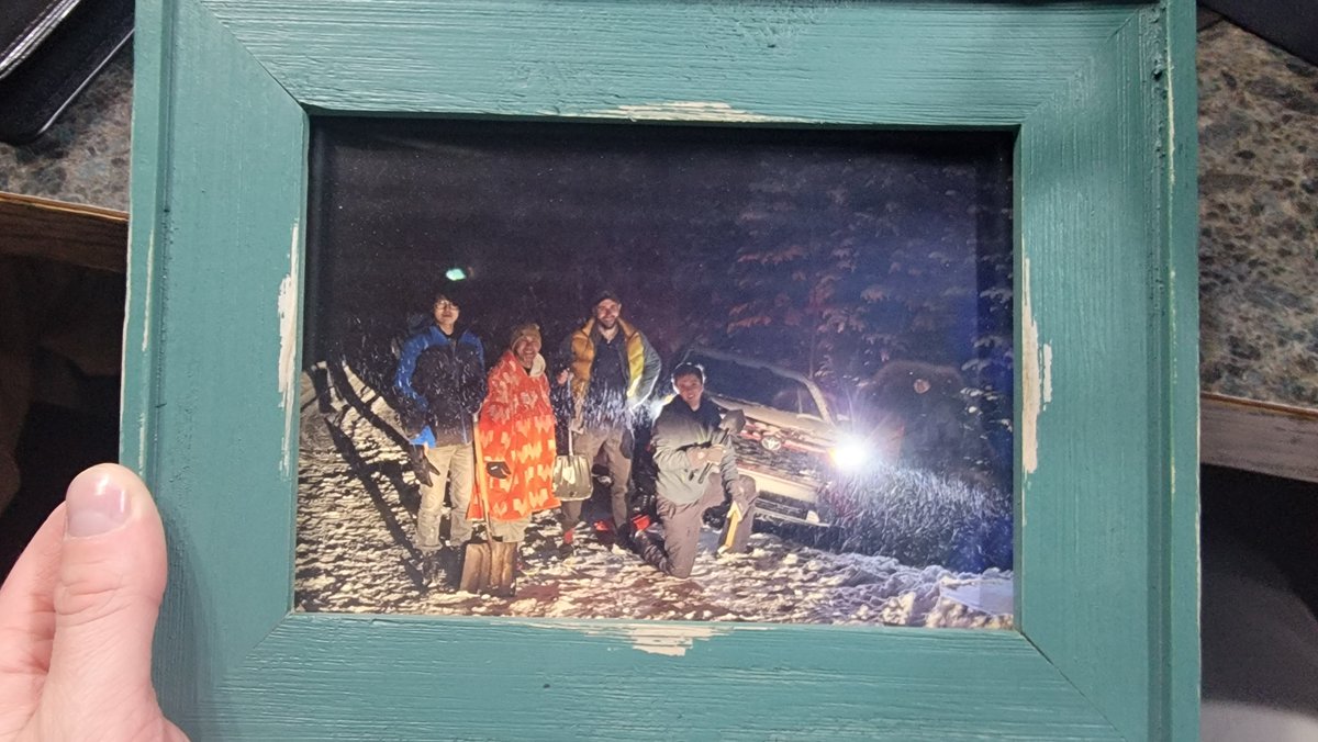 For context, I'm out at hotpot with friends and at the end @smolmutt hands me a gift bag saying it's from everyone to me. Inside is a framed photograph of some of them and MY CAR STUCK IN A SNOW BANK???