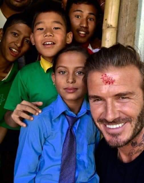 David Beckham with the children of Bhaktapur after the friendly soccer match in 2015.

#DavidBeckham #Bhaktapur #SoccerMatch #CommunityEngagement #SportsForAll