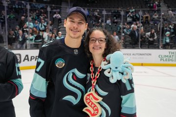 Gourde poses for a photo with a fan