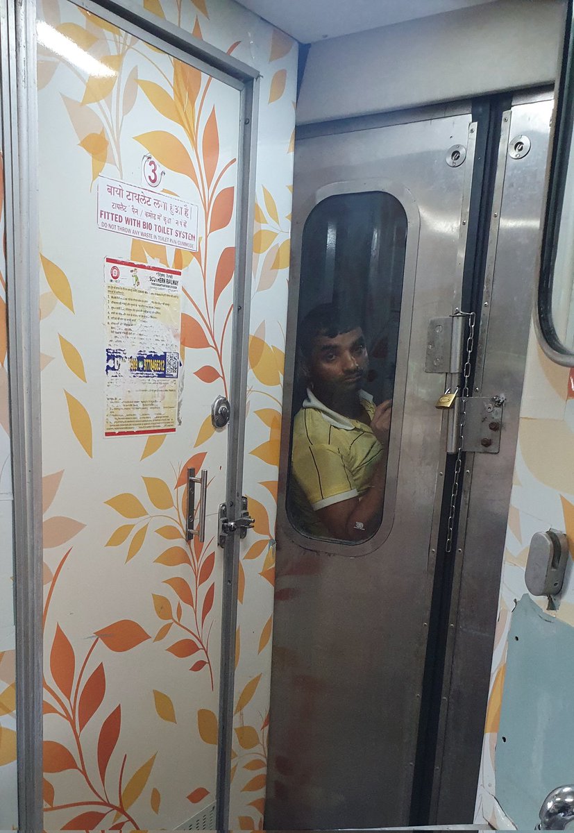 This picture going to haunt me for a long time. This man standing on this pose on a UR compartment seperator for more than 24 hours on train no.12617 began on 11th April,24. One night passed, don't know how many nights he will stand like this. Felt very sad @RailMinIndia 1 of 2