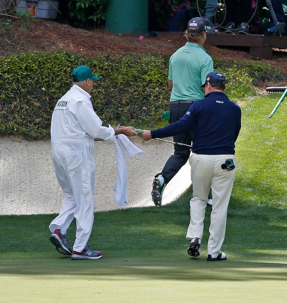 Neil Oxman hands Tom Watson an egg salad sandwich as they leave the 12th green in Tom’s final appearance at the Masters in 2016 - After Bruce Edwards died in 2004 Tom would always leave a sandwich on the 13th tee bench in memory of his friend and caddie.