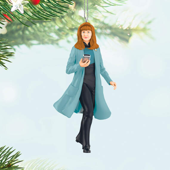 Hallmark's new #StarTrek ornaments for 2024 were officially announced today, starting with Dr. Beverly Crusher! Clad in her trademark blue coat and with trusty medical tricorder in hand, the Crusher ornament will arrive in October for $19.99. hallmark.com/ornaments/keep…