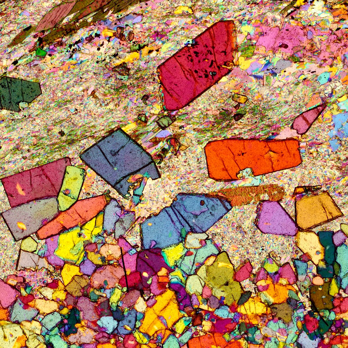 More of the lovely staurolite aggregates in the metapelites from the the Vedrette di Ries contact aureole (eastern Alps, Italy). Crossed polars and lambda plates. Width 1.5 mm. #science #geology #rocks #minerals #Alps #colors #staurolite #microscope #photography