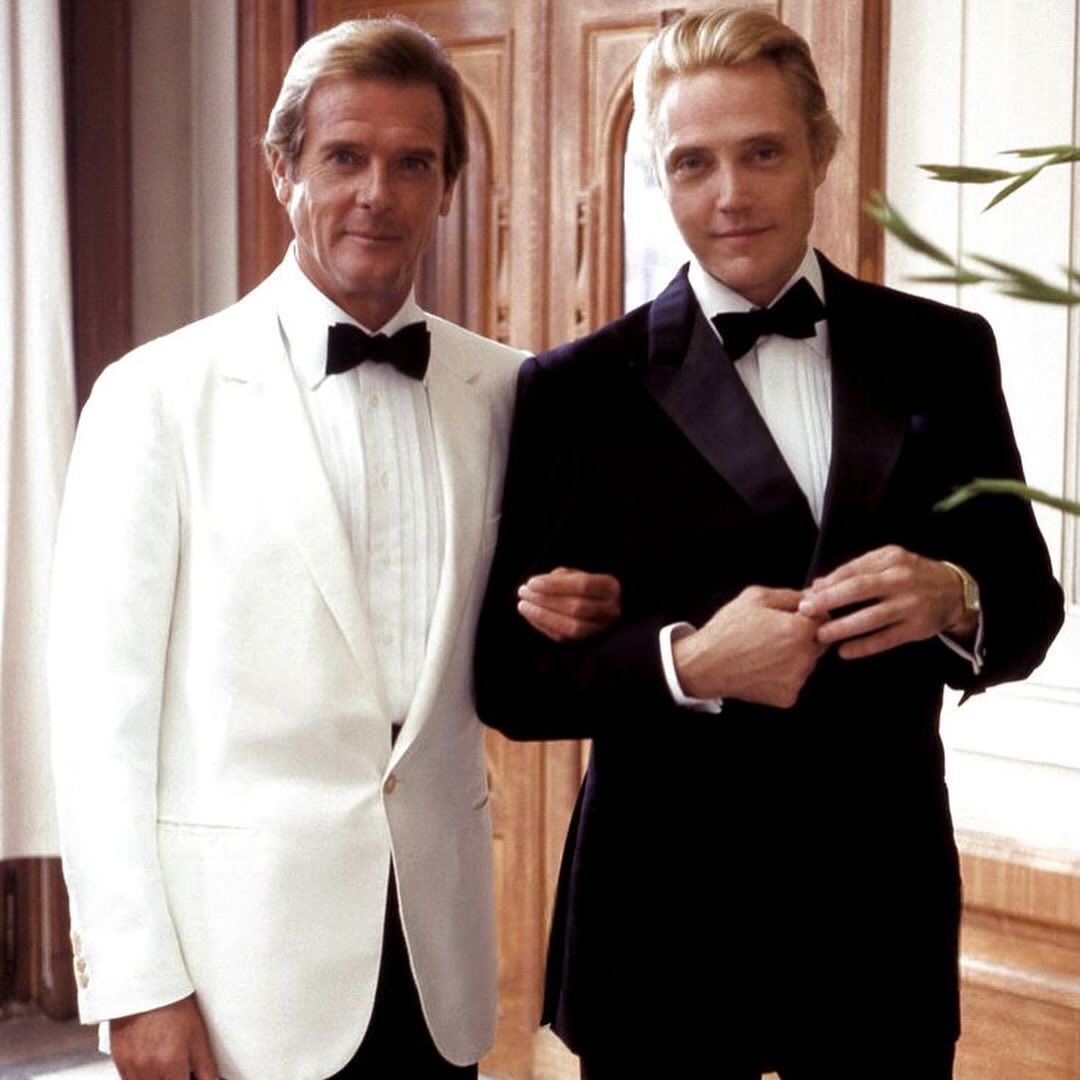 A behind the scenes photo of Sir Roger Moore and Christopher Walken on the set of A VIEW TO A KILL (1985).