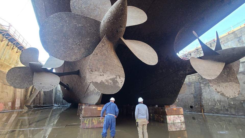 USS New Jersey is now high and dry (curator for scale), a small amount of water is being retained to facilitate the de-mudding and de-fishing of the drydock, but she's almost ready for work. (Photo courtesy of Ryan and @BattleshipNJ ) Drydock tours are available!